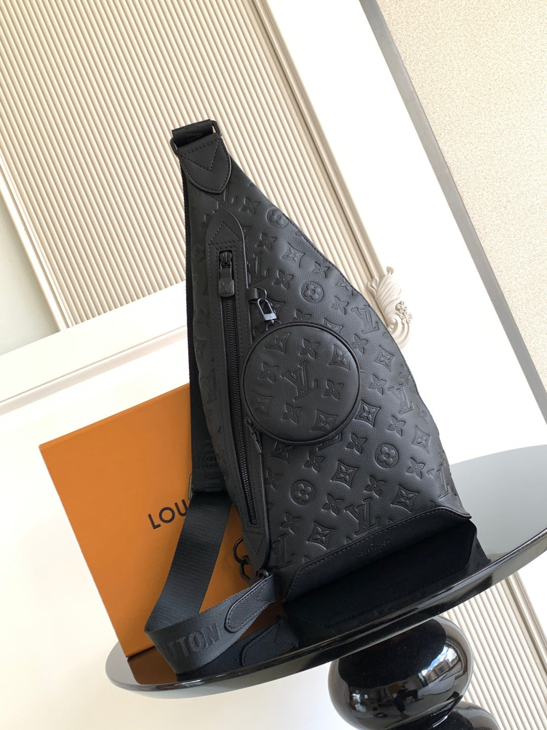Louis Vuitton bag in dark embossed monogram leather, front flap and shoulder strap