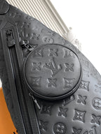 Louis Vuitton bag close-up in dark embossed monogram leather with round emblem and zipper