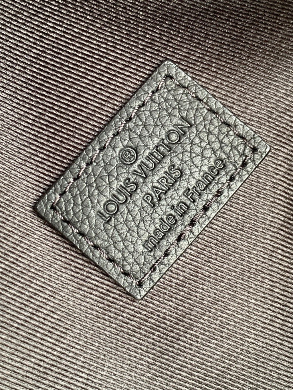 Louis Vuitton bag leather label patch with "Louis Vuitton Paris" and "made in France" text