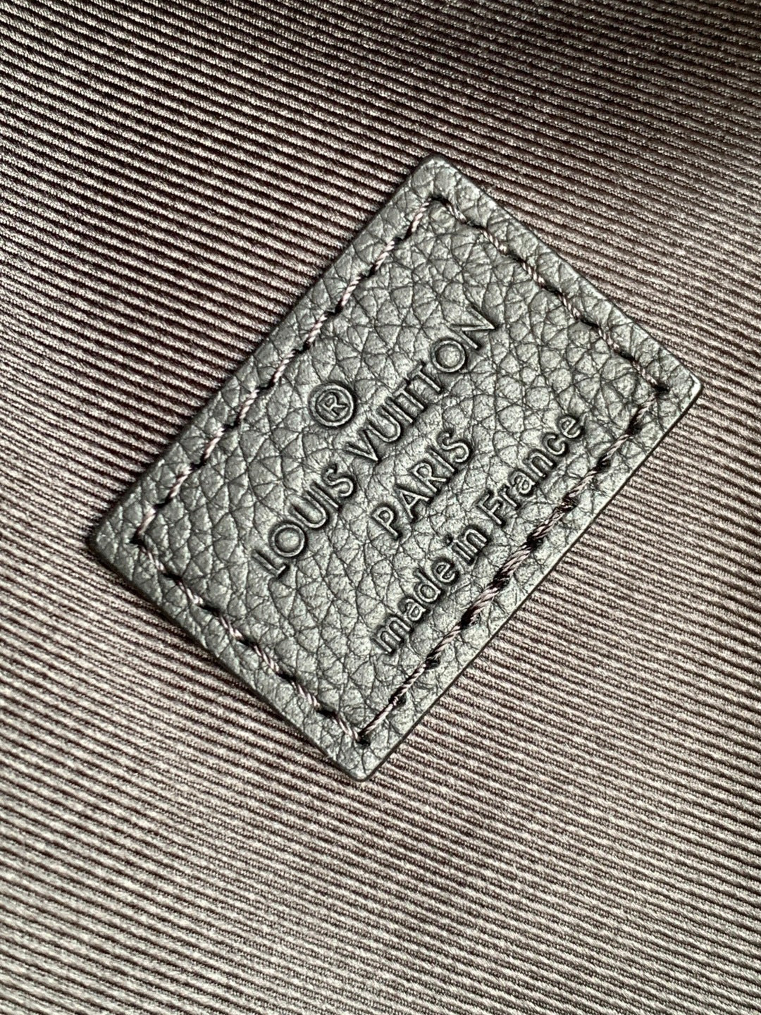 Louis Vuitton bag leather label patch with "Louis Vuitton Paris" and "made in France" text