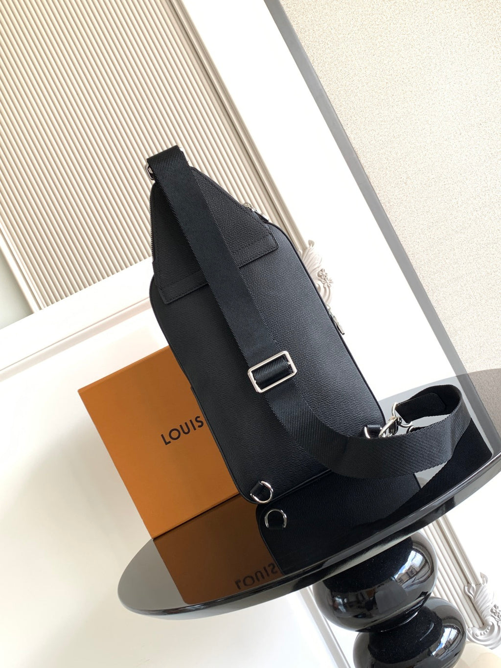 Louis Vuitton black leather crossbody bag with adjustable shoulder strap