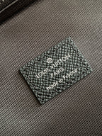 Louis Vuitton black leather logo patch with "Louis Vuitton" text