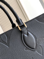 Louis Vuitton tote bag handle and front emblem detail in dark textured leather