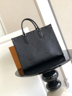Louis Vuitton embossed tote bag with structured shape and top handles
