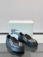 Black low-top sneakers with plaid side panels and lace-up closure, angled view
