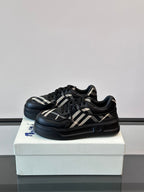 Black low-top sneakers with plaid accents and padded collar, shown from side