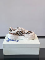White leather low-top sneakers with Burberry check stripe and lace-up front, side view