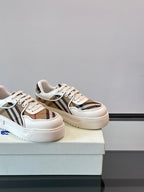 White leather low-top sneakers, angled view with Burberry check stripe and laces