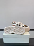 White rubber-sole sneakers, outsole view with Burberry check upper