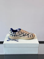 Burberry low-top lace-up sneaker on box; beige plaid upper with blue heel collar