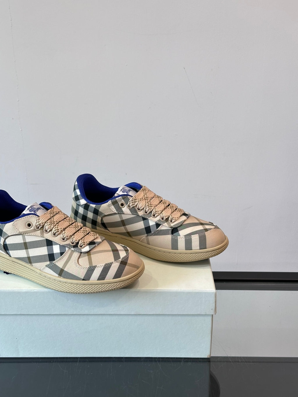 Burberry lace-up sneakers, close side view; beige check print with blue heel detail