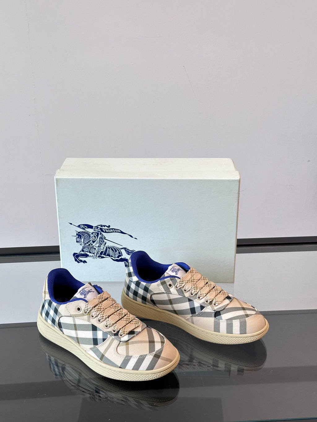 Burberry sneakers with beige plaid and blue collar, pair view on display box
