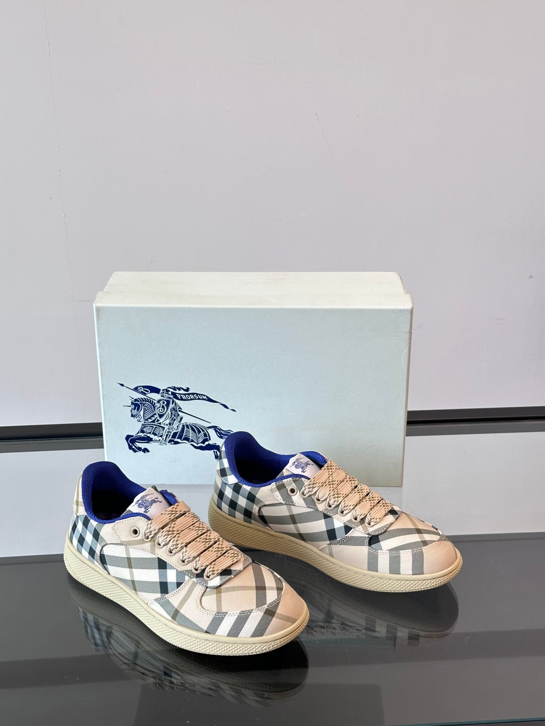 Burberry sneakers with beige plaid and blue collar, pair view on display box