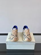 Burberry low-top sneakers, front view, beige plaid upper with blue lining and laces