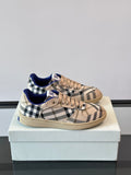 Burberry lace-up sneakers with beige plaid, blue interior, and tan rubber sole
