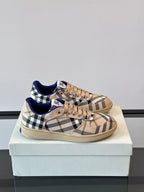 Burberry lace-up sneakers with beige plaid, blue interior, and tan rubber sole