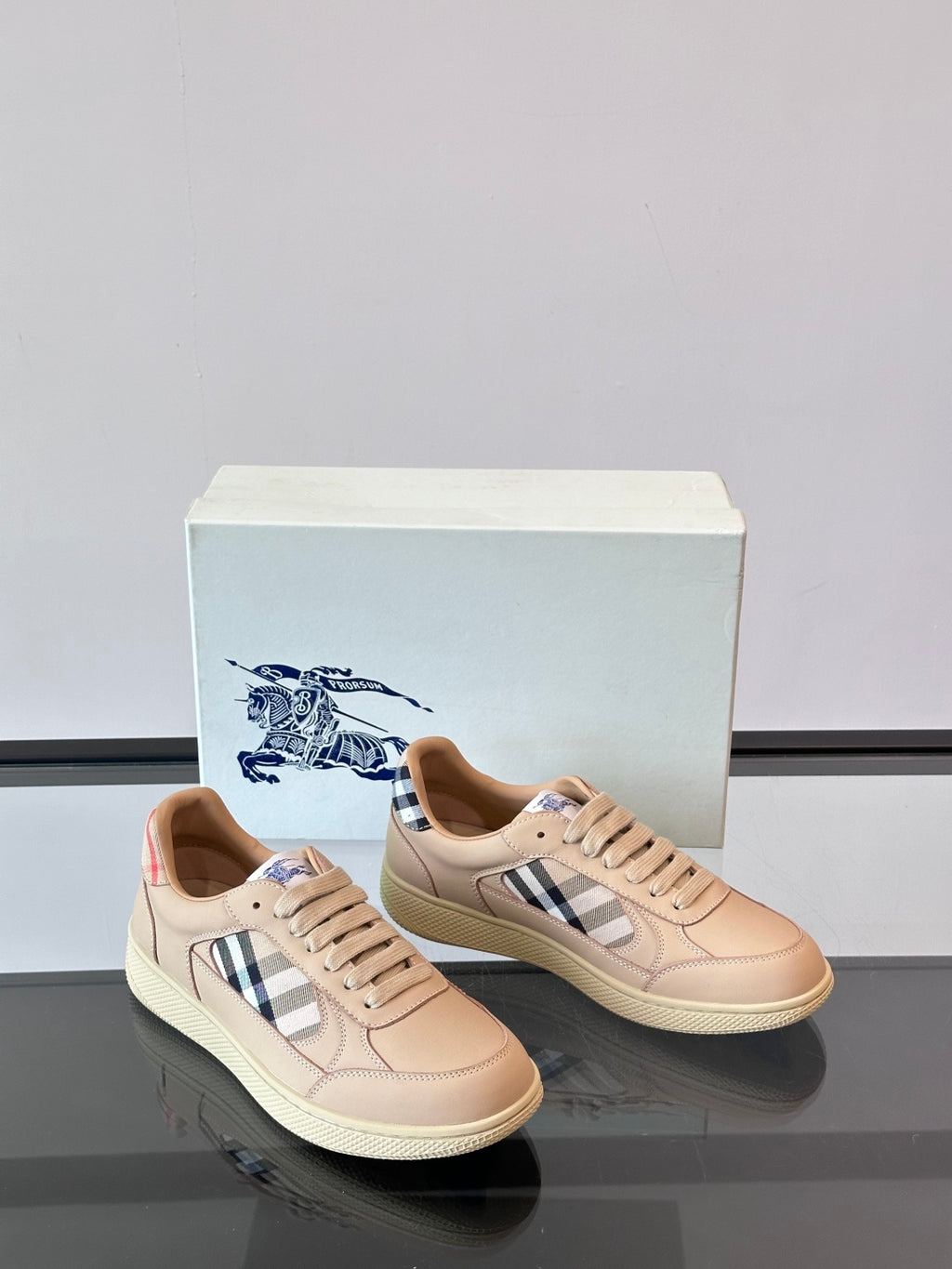 Sneakers with Burberry check accents, beige leather uppers and blue logo heel