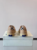 Back view of beige sneakers with Burberry check lining and blue heel accents