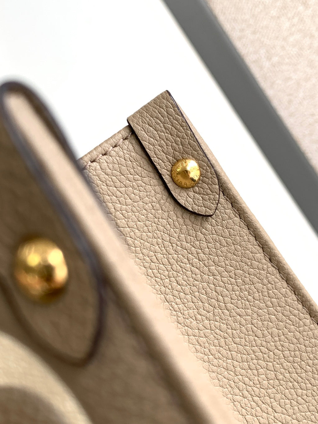 Louis Vuitton leather bag corner in taupe with snap closure and gold accent