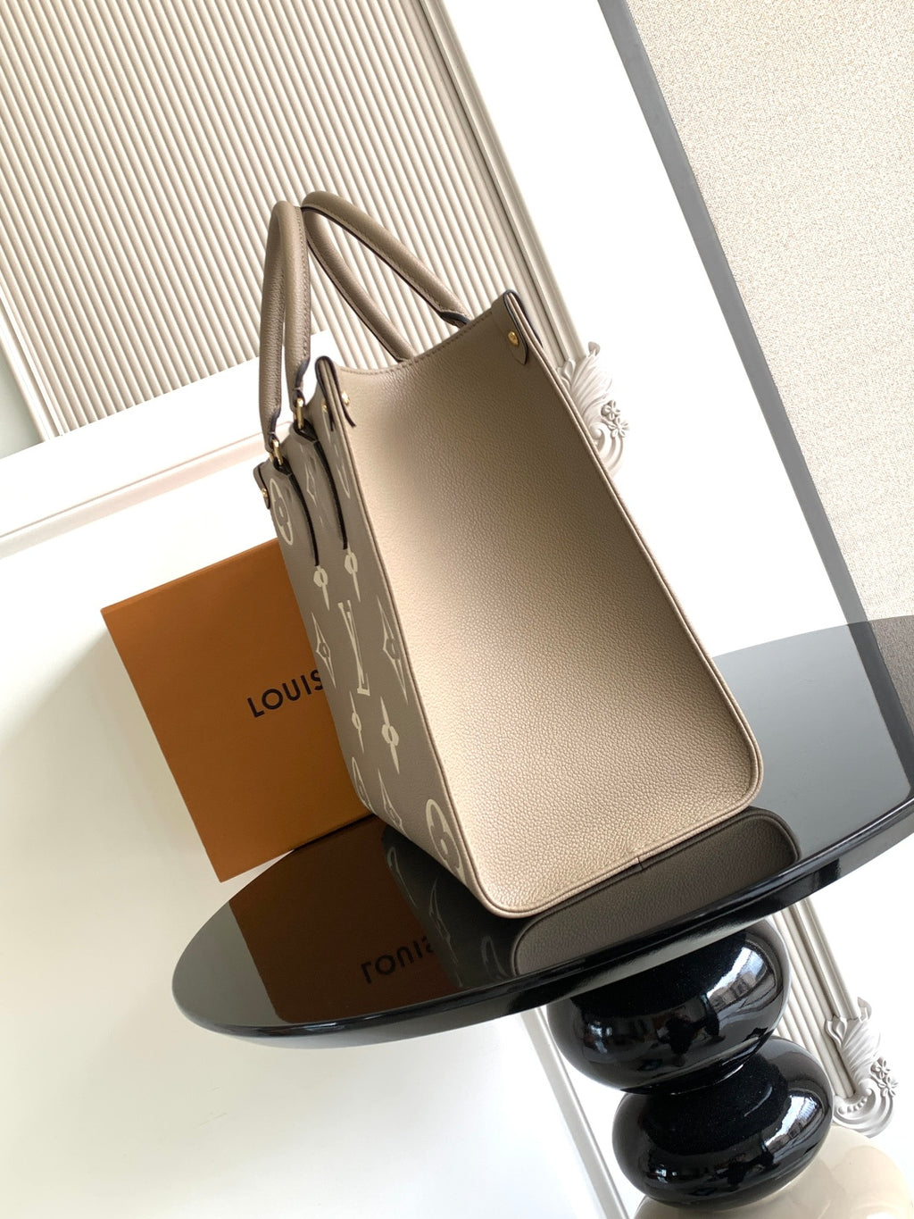 Louis Vuitton structured tote bag in light taupe with monogram detailing and handles