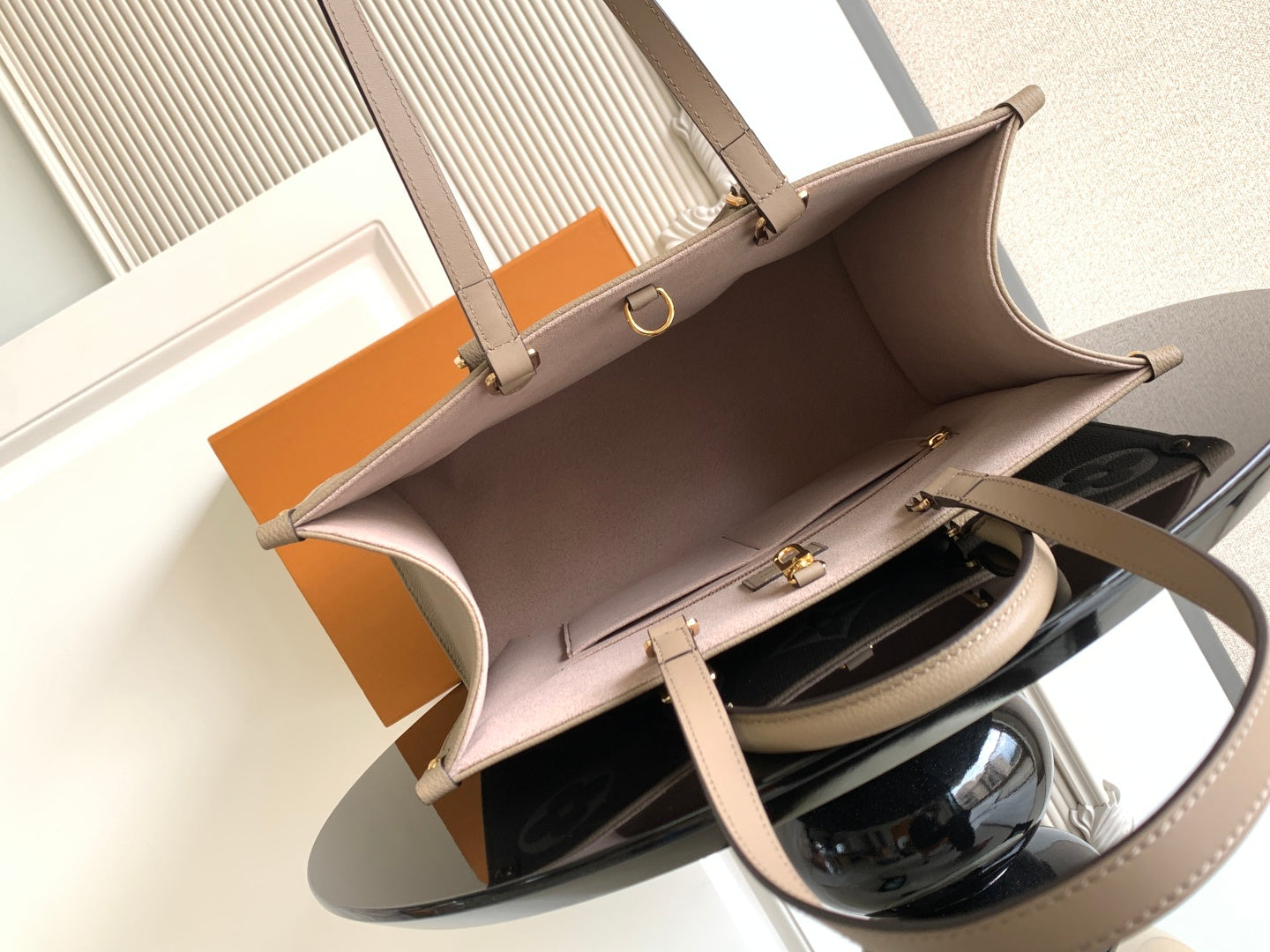 Louis Vuitton tote bag open with taupe interior and top handles