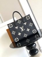 Louis Vuitton tote bag with dark monogram pattern, top handles, and gold-tone hardware