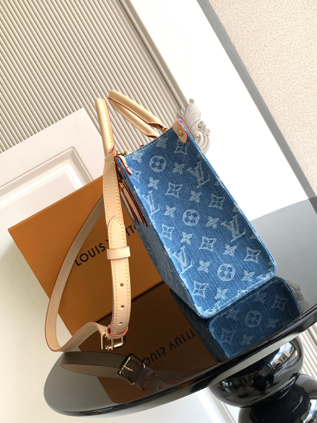 Louis Vuitton denim tote bag with adjustable shoulder strap and stacked handles