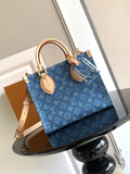 Louis Vuitton denim tote bag with dual top handles and gold-tone hardware