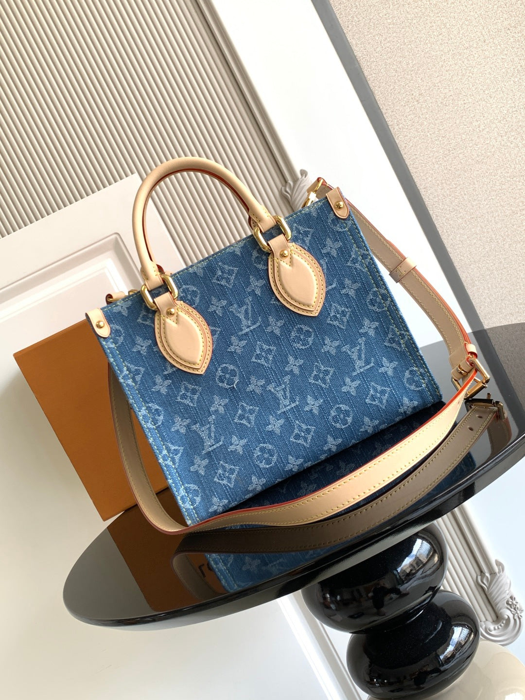 Louis Vuitton denim tote bag with top handles and tan leather trim