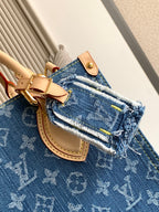 Louis Vuitton denim tote bag close-up of logo pattern, top handle and clasp