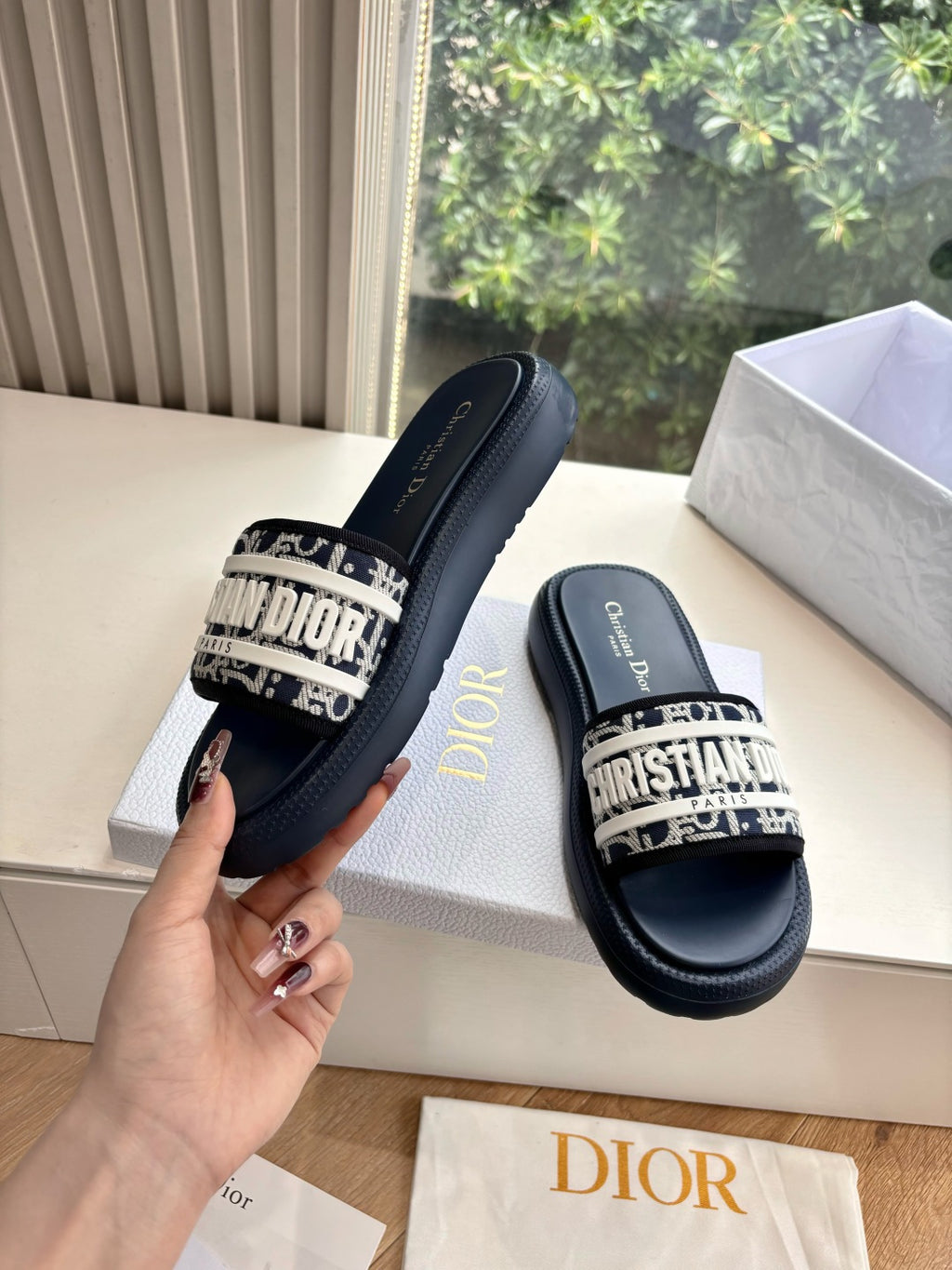 Women’s slide sandals, dark leather with patterned strap and gold Dior detail