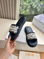 Women’s slide sandals, dark leather with patterned strap and gold Dior detail