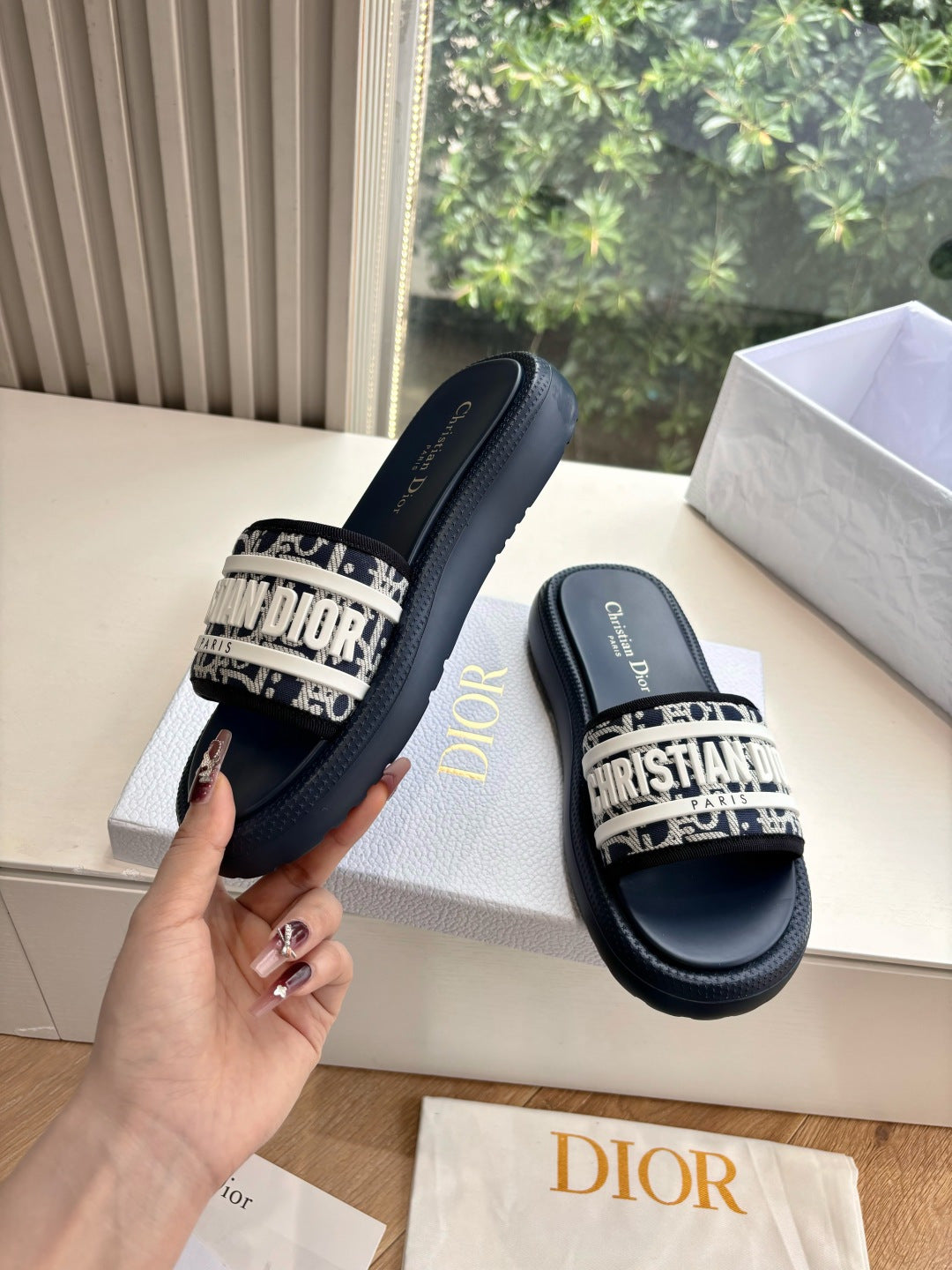 Women’s slide sandals, dark leather with patterned strap and gold Dior detail