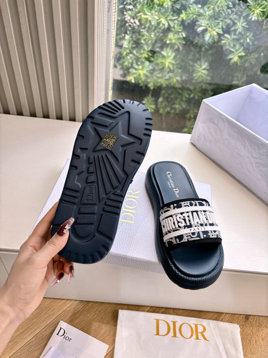 Women’s slide sandals with textured rubber outsole and patterned strap