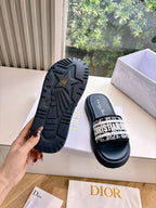 Women’s slide sandals with textured rubber outsole and patterned strap