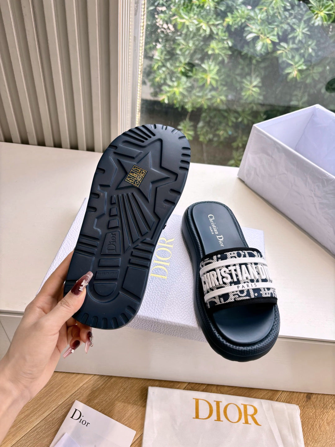 Women’s slide sandals with textured rubber outsole and patterned strap