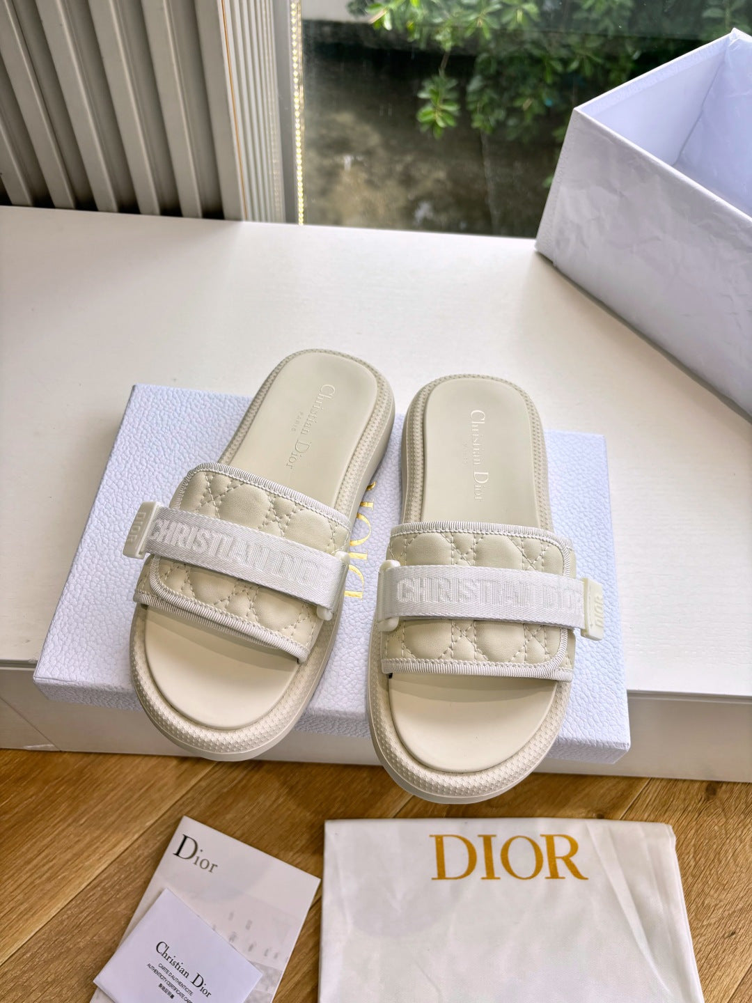Dior ladies slide sandals, light beige, front view; wide strap and ridged platform sole