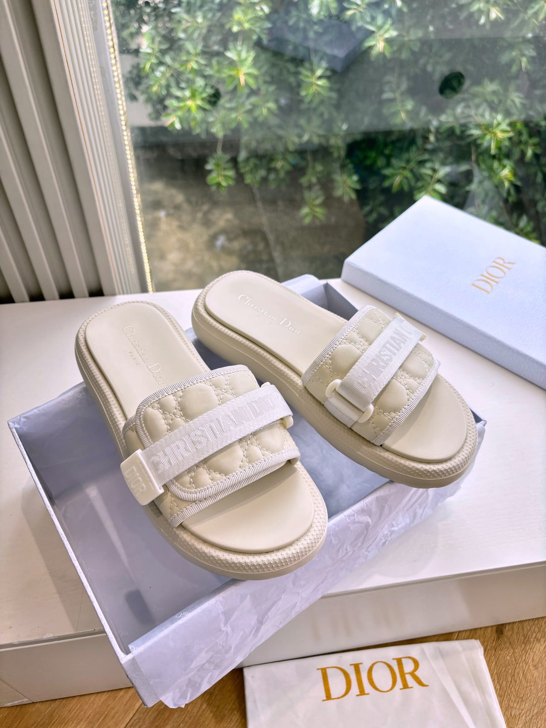 Dior ladies slide sandals in light beige with wide embossed strap and textured sole