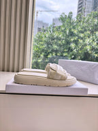 Dior ladies slide sandals, light beige, profile view on box