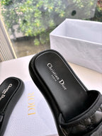 Black slide sandal footbed with “Christian Dior” logo, shown close-up with strap top