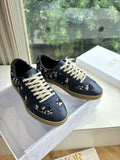 Navy low-top lace-up sneakers with off-white laces and logo print panels
