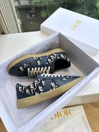 Navy low-top lace-up sneakers with logo print uppers and light outsole
