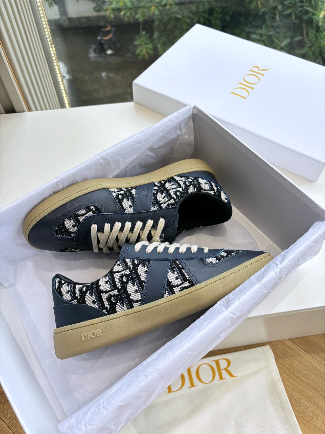 Navy low-top lace-up sneakers with logo print uppers and light outsole