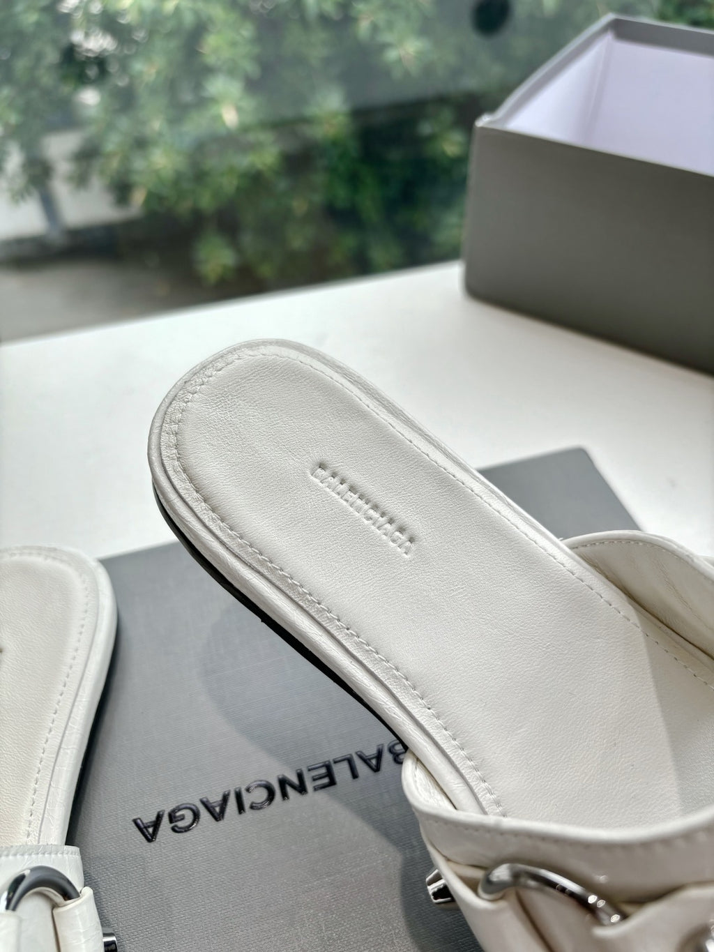 Balenciaga women's sandals, light cream footbed close-up with BALENCIAGA text