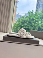 Balenciaga women's slide sandals, light cream, side profile with two buckle straps