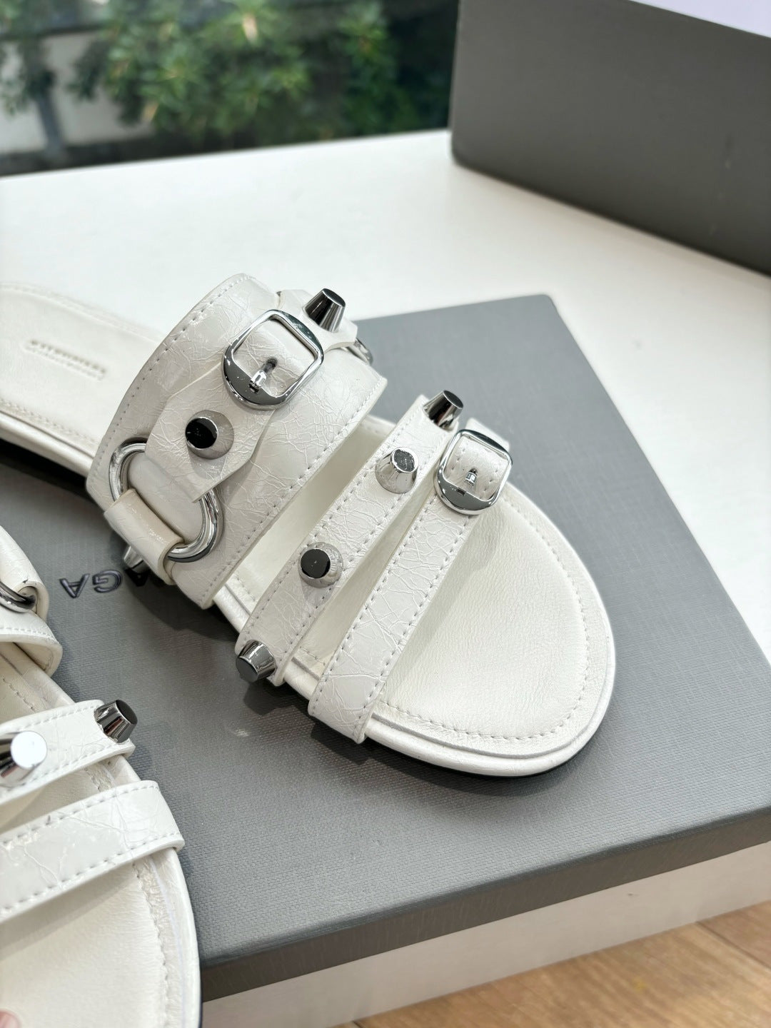 Balenciaga women's sandals, light cream, close-up of double straps and buckles