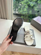 Balenciaga women's slide sandal showing sole, light cream upper