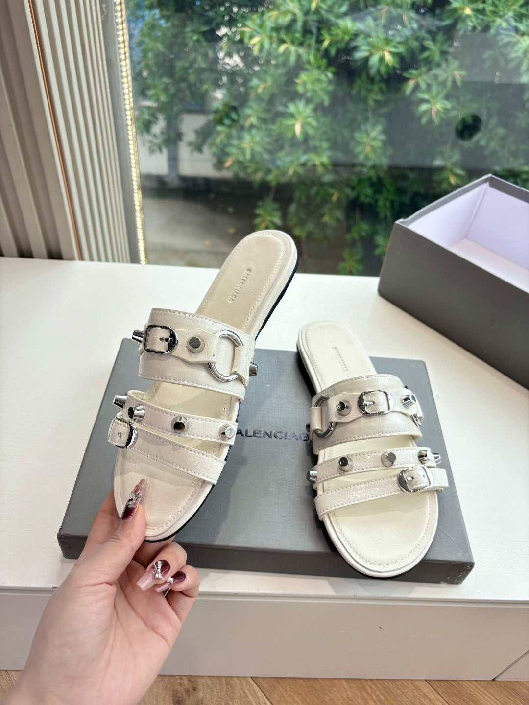 Balenciaga women's slide sandal in light cream with metal buckle strap detail