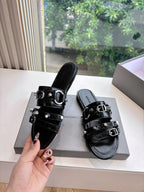Black slide sandals with stacked straps, silver buckle hardware, side view