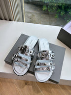 Metallic silver slide sandals with two adjustable buckle straps, closed sides